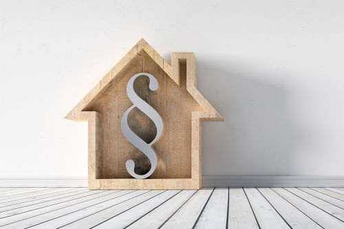 Häuschen mit Paragraf-Zeichen darin